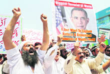 Activists associated with the Muthahida Shehri Mahaz (United Citizens Alliance) shout anti-American slogans while holding an image of US President Barack Obama during a protest condemning the killing of Osama bin Laden in Multan.