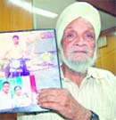Dilbag Singh Gill shows a picture of his late son