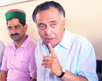GS Bali (R), Nagrota Bagwan MLA, along with Kewal Singh Pathania, Congress spokesman, addresses a press conference at Dharamsala on Tuesday. 