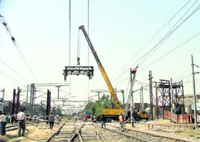 A crane lifts the cut-off span of Lakkar Bridge in Ludhiana on Tuesday