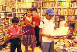 Children dig into comics at the Capital Book Depot