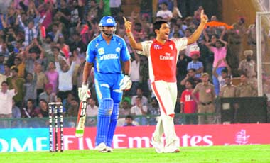 Kings XI Punjabs Bhargav Bhatt celebrates the wicket of Kieron Pollard in Mohali on Tuesday. Kings XI won the match by 76 runs
