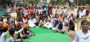 Labourers blocking the Faridkot-Ferozepur highway at Golewal village on Wednesday; The labourer Veer Singh (inset) who tried to commit suicide.