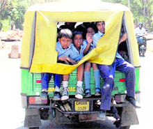 tudents sit precariously on the rear side of the autorickshaw in Chandigarh
