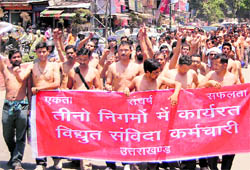 Contractual employees of the three power corporations hold a march in Dehradun on Wednesday