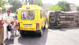 Parents take their kids home after their school van met with an accident at Sector 9 in Chandigarh on Thursday