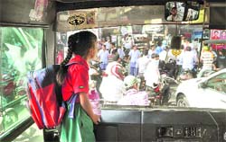 Mansi, a class I student, waits for her father after being caught up in the protest of nursing students in Ludhiana