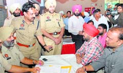 Teja Singh seeks justice at Dara Studio, Phase VI,  (laft) and a police team addresses the public in Mohali 