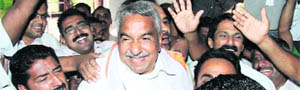 UDF leader Oommen Chandy and his supporters celebrate the partys victory in Kochi.