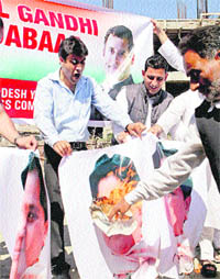 Congress workers burn posters of Uttar Pradesh Chief Minister Mayawati during