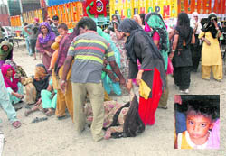 Relatives try to console mother of seven-year-old Vishal (inset), a ragpicker, who was run over by a truck at Transport Nagar in Ludhiana on Friday. 