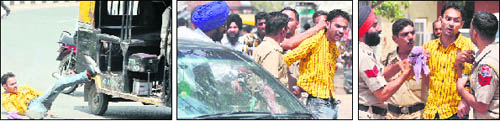 Con man falls on the road after being hit by an auto-rickshaw, nabbed by cops after a long chase; and (right) argues with them after being caught near the Bus Stand Chowk at Jagraon on Friday.Tribune photos:Himanshu Mahajan