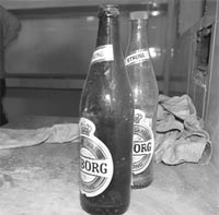 Empty beer bottles in the kitchen of an eating place that has been shut down.