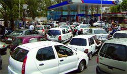Vehicles queue up at a petrol station