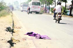 A garment belonging to Vijay Kumar, who dled in an accident, lies on NH-I near Ludhiana