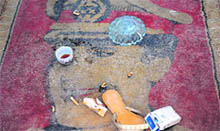 Libyans disgrace an image of Gaddafi painted on a carpet in Benghazi on Friday. 