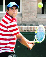 A player plays a shot during a match of the AITA-CLTA tennis tournament in Chandigarh on Sunday.