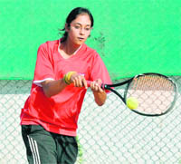 A player in action during a tennis match in Mohali on Sunday.