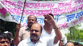 BJP activists shout slogans against the Congress government over the hike in the prices of petroleum products and milk in New Delhi on Sunday