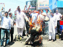 Workers of the Uttarakhand Kranti Dal (Panwar) burn an effigy of the Central Government in protest against the hike in petrol prices in Dehradun on Sunday. 