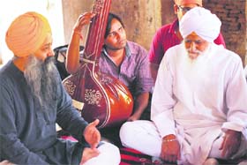 Bhai Gurcharan Singh Ragi (in white) breathes a new life of music in Darbar hall of Quila Sarai on the inaugural day of devotional music classes initiated by Anad Conservatory