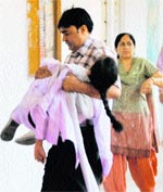 In safe hands The girl who fainted being rushed inside the school premises.
