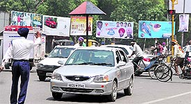 A traffic cop stops a car for jumping a red light.