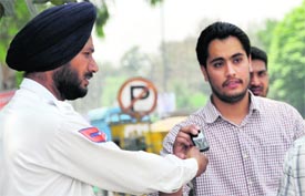 A violator hands a traffic cop his cell phone to talk to a VIP.