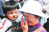 A tearful family leaves Iitate village. 