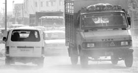 A car moves on the wrong side on the Zirakpur-Panchkula highway near the railway line.