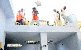 Workers demolish part of a house in Sector 22, Chandigarh, during a demolition drive carried out by the Estate Office on Monday.