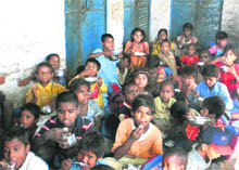Children take mid-day meal at a brick-kiln school in Jhajjar. 