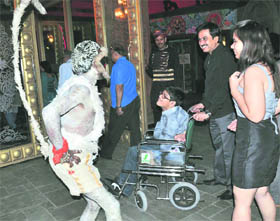 A differently abled child is amused on seeing a man dressed as a monkey at a function in Gurgaon. 
