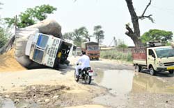 A loaded truck overturns on the Moga road near bus stand at Shahkot in Nakodar on Monday. The driver of the truck alleged that the bad condition of the road led to the accident