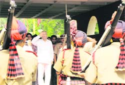 Newly inducted Punjab Health Minister Satpal Gosain salutes at a guard of honour at the Circuit House on his first visit to his home town after assuming office