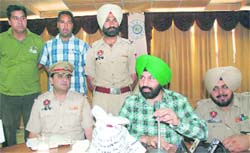 SSP Sukhchain Singh Gill (with mike) shows the seized heroin to the media in Bathinda