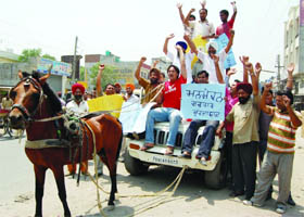 BJP workers protest against petrol price hike in Amritsar.