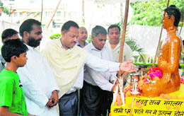 People pay obeisance to an idol of Lord Buddha on the occasion of Budh Poornima in Dehradun on Tuesday. 