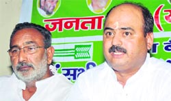 State unit in charge of the Janata Dal (United) Suraj Shrivastav (right) announces the party's political programme in Haridwar on Tuesday.