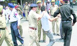 The police takes into custody agitating ETT students at Chandigrh Chowk in Nawanshahr