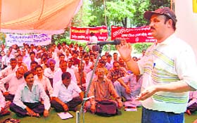 Employees of various corporations of the Uttarakhand Government stage a dharna at Gandhi Park in Dehradun on Wednesday