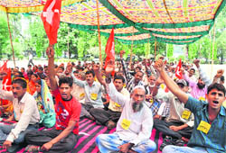Forest dwellers under the banner of the Akhil Bharatiya Kisan Mahasabha hold a protest in support of their demands in Dehradun on Wednesday