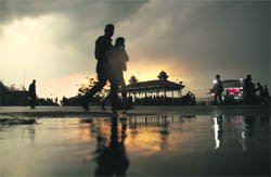 People enjoy a sudden rain in Shimla on Tuesday evening