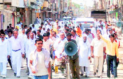 Members of the sangharsh samiti hold a protest march at Ellenabad on Wednesday.