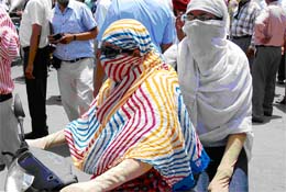 Girls protect themselves from the summer heat while moving around in Bathinda on a hot Thursday afternoon