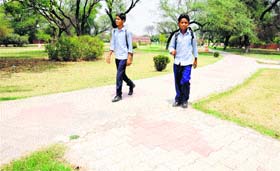 CONCRETE POLICY Schoolchildren walk on concrete footpaths laid in a park in Chandigarh
