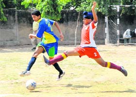 GOAL ORIENTED Young footballers slug it out during a match at St Soldiers School in Sector 28, Chandigarh, on Thursday