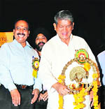 Union Minister of State for Agriculture and Food Processing Industry Harish Rawat lights the traditional lamp at the inauguration of a seminar at the NDRI, Karnal, on Thursday.
