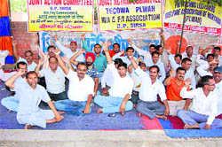 Polytechnic teachers stage a dharna outside their institute in Sirsa on Thursday.