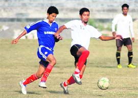 Players try to take control of the ball in a match in the Presidents Cup Football Tournament in Dehradun on Friday.